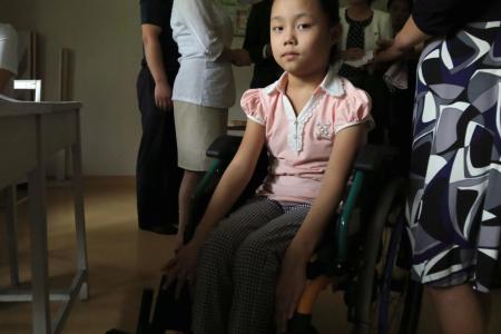A girl in a wheelchair at the Korea Rehabilitation Centre for Children with Disabilities, Pyongyang